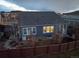 Back exterior of the home with a fenced yard and visible basement window wells at 14232 Elm St, Thornton, CO 80602