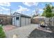 Cozy backyard features a gray shed, gravel area, and a fire pit for relaxing outdoor enjoyment at 2244 N Washington St, Denver, CO 80205