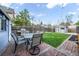 Backyard featuring brick patio, dining set, grass lawn, and storage shed, ideal for outdoor activities and storage at 2244 N Washington St, Denver, CO 80205