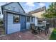 Backyard with blue building, brick patio, and outdoor dining set, ideal for entertaining and relaxation at 2244 N Washington St, Denver, CO 80205