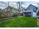 Backyard featuring a brick patio, dining set, playhouse, grass, and storage shed, designed for outdoor living at 2244 N Washington St, Denver, CO 80205