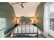 This charming bedroom has a black metal bed frame, and a ceiling fan at 2244 N Washington St, Denver, CO 80205