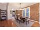 Stylish dining area with exposed brick wall and open concept, seamlessly connecting to the kitchen at 2244 N Washington St, Denver, CO 80205