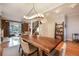 Spacious dining area with hardwood floors, modern light fixture and brick accent wall at 2244 N Washington St, Denver, CO 80205