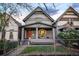 Charming grey two-story home with a cozy front porch and vibrant orange front door at 2244 N Washington St, Denver, CO 80205