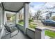Relaxing front porch with brick columns and comfortable seating overlooking a lovely street view at 2244 N Washington St, Denver, CO 80205