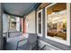 Comfortable front porch with chairs and a table offering a view of the neighborhood and sunset at 2244 N Washington St, Denver, CO 80205