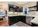 Sleek kitchen with black cabinetry, stainless steel appliances, and mosaic tile backsplash, open to the dining area at 2244 N Washington St, Denver, CO 80205