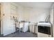 Laundry room featuring a sink, white brick wall, updated washer and dryer providing a clean and functional space at 2244 N Washington St, Denver, CO 80205