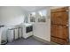 Bright laundry room featuring updated washer and dryer and a wooden door, offering practicality with natural light at 2244 N Washington St, Denver, CO 80205
