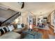 Open-concept living space with staircase, hardwood floors, and view into the dining area at 2244 N Washington St, Denver, CO 80205