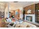 Stylish living room with exposed brick wall, fireplace, and open floor plan to dining area at 2244 N Washington St, Denver, CO 80205