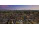 Aerial shot of a neighborhood with tree-lined streets against a vibrant sunset sky at 2441 Niagara St, Denver, CO 80207