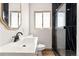 Bright bathroom featuring modern fixtures, a sleek vanity, and a luxurious glass-enclosed shower with black marble accents at 2441 Niagara St, Denver, CO 80207