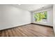 Bright bedroom featuring wood floors and natural lighting from a large window at 2441 Niagara St, Denver, CO 80207