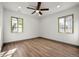 Bright bedroom with wood floors, neutral paint, and dual windows offering natural light at 2441 Niagara St, Denver, CO 80207