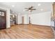 Open living room featuring wood floors, neutral paint, and access to multiple rooms at 2441 Niagara St, Denver, CO 80207
