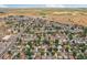 Aerial view showcasing neighborhood featuring single-Gathering homes, tree-lined streets, and landscape surroundings at 7940 Pontiac St, Commerce City, CO 80022
