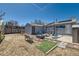 Backyard with patio area, blue chairs, fire pit, greenhouse, and storage shed, perfect for entertaining at 7940 Pontiac St, Commerce City, CO 80022