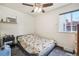 Bright bedroom with a ceiling fan, cozy bed and natural light at 7940 Pontiac St, Commerce City, CO 80022