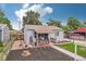Inviting home featuring a covered porch, mulch groundcover and blue sky background at 7940 Pontiac St, Commerce City, CO 80022