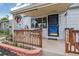 Close-up of the front porch, with wooden railings, flower pots, and the house number 7940 displayed at 7940 Pontiac St, Commerce City, CO 80022