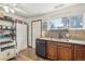 Kitchen featuring wood cabinets, granite countertops and modern black appliances at 7940 Pontiac St, Commerce City, CO 80022