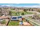 Beautiful aerial view showing the fenced backyard, solar panels, nearby park, and neighborhood, surrounded by mountains at 6376 S Estes St, Littleton, CO 80123