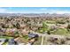 Scenic aerial view of the neighborhood, featuring lush greenery, nearby park, and solar panels on the house roof at 6376 S Estes St, Littleton, CO 80123