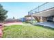 Manicured backyard with a sandbox, garden area, and a covered patio offers outdoor enjoyment at 6376 S Estes St, Littleton, CO 80123