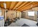 Spacious unfinished garage with exposed beams and storage, great for projects at 6376 S Estes St, Littleton, CO 80123