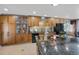Elegant kitchen featuring custom cabinets, a black fridge, and a stylish backsplash over the countertop at 6376 S Estes St, Littleton, CO 80123