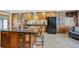 Stylish kitchen with a central island and bar stools, complemented by custom cabinets and black appliances at 6376 S Estes St, Littleton, CO 80123