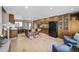 Spacious kitchen with custom cabinetry, granite countertops, black appliances, and central island seating at 6376 S Estes St, Littleton, CO 80123