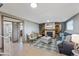 Cozy living room with tiled flooring, stylish furniture, a fireplace, and access to other rooms at 6376 S Estes St, Littleton, CO 80123