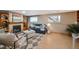 Cozy living room features a fireplace, plush seating, and ample natural light at 6376 S Estes St, Littleton, CO 80123