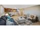 Comfortable living room with stylish seating, built-in bookshelves, and staircase access at 6376 S Estes St, Littleton, CO 80123