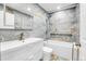 Stylish bathroom with blue marble tiling, sleek fixtures, and a built-in shower niche at 4678 S Salida St, Aurora, CO 80015