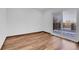 Bright bedroom featuring laminate flooring and sliding glass door at 4678 S Salida St, Aurora, CO 80015