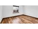 Bright bedroom featuring laminate flooring and a window letting in natural light at 4678 S Salida St, Aurora, CO 80015