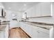 Modern kitchen featuring sleek white cabinets, stainless steel appliances, and hardwood floors at 4678 S Salida St, Aurora, CO 80015