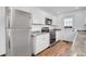 Well-equipped kitchen with stainless steel appliances, white cabinets and hardwood floors at 4678 S Salida St, Aurora, CO 80015