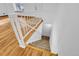 Staircase featuring hardwood flooring with carpeted stairs and a white railing at 4678 S Salida St, Aurora, CO 80015