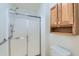 Shower with sliding glass doors, plus a wooden cabinet and toilet in this bathroom at 2585 E Egbert St, Brighton, CO 80601