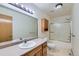 Bathroom boasts a vanity, sink, mirror, lighting, medicine cabinet and shower with glass doors at 2585 E Egbert St, Brighton, CO 80601