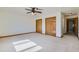 Spacious bedroom featuring a ceiling fan, plush carpeting, and a large double-door closet at 2585 E Egbert St, Brighton, CO 80601