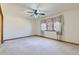 Bright bedroom with window and curtains, ceiling fan, and neutral carpet at 2585 E Egbert St, Brighton, CO 80601