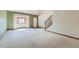 Bright, airy living room featuring neutral paint, plush carpeting, and large windows with abundant natural light at 2585 E Egbert St, Brighton, CO 80601