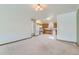 Bright living space connected to the kitchen featuring tile floors, oak cabinets, and modern appliances at 2585 E Egbert St, Brighton, CO 80601