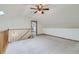 Carpeted loft area with skylight, vaulted ceiling, and railing at 2585 E Egbert St, Brighton, CO 80601